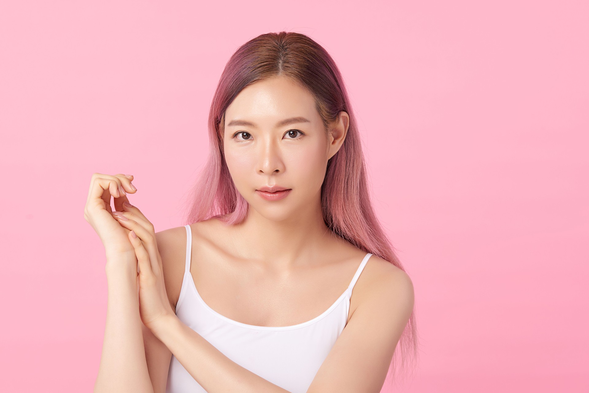 Beautiful Young asian Woman with Clean Fresh Skin, on Pink background, Face care, Facial treatment. Cosmetology, beauty and spa. Asian women portrait